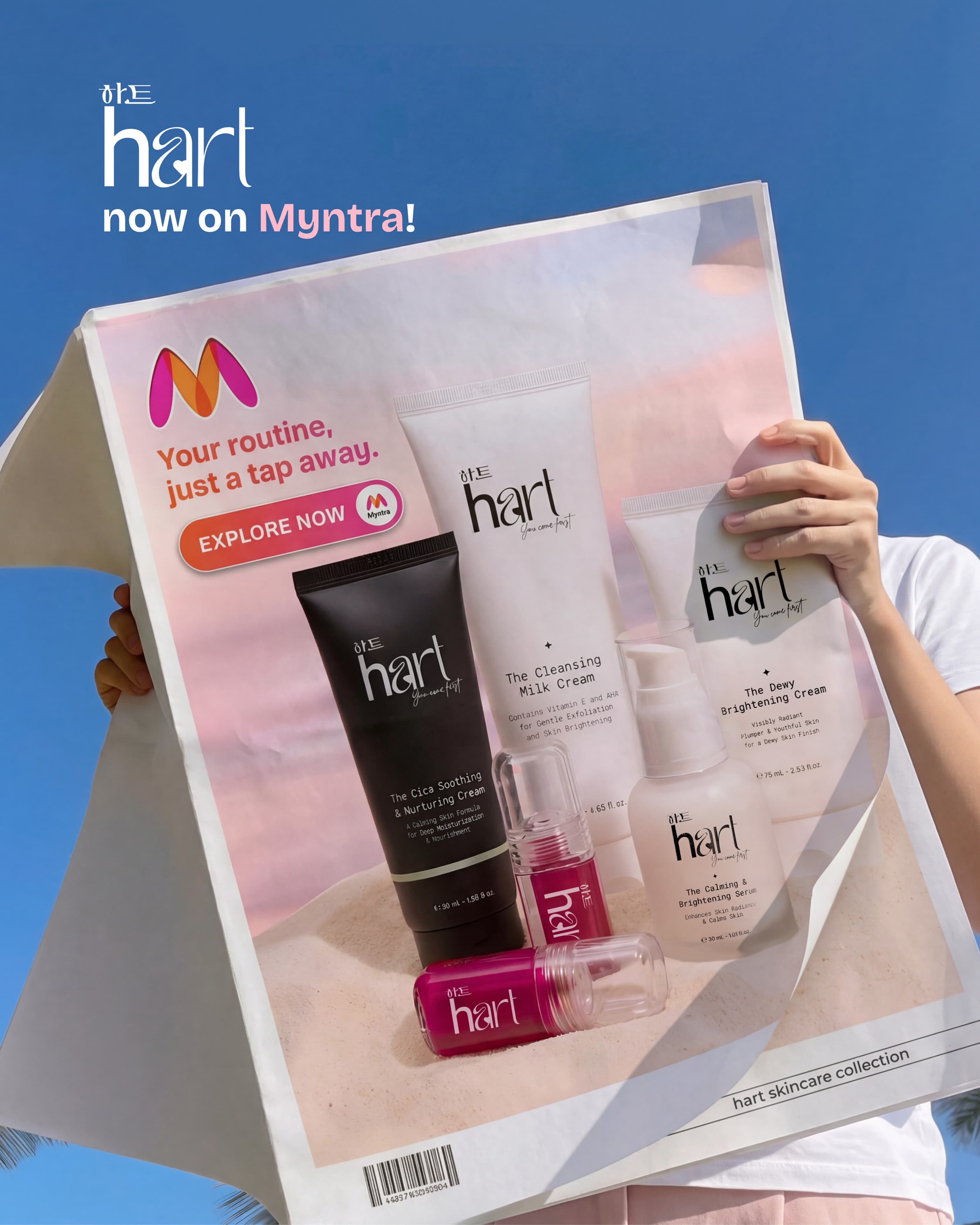 'HART now on Myntra' post: a hand holding up a printed Myntra ad of the full HART range against a blue sky
