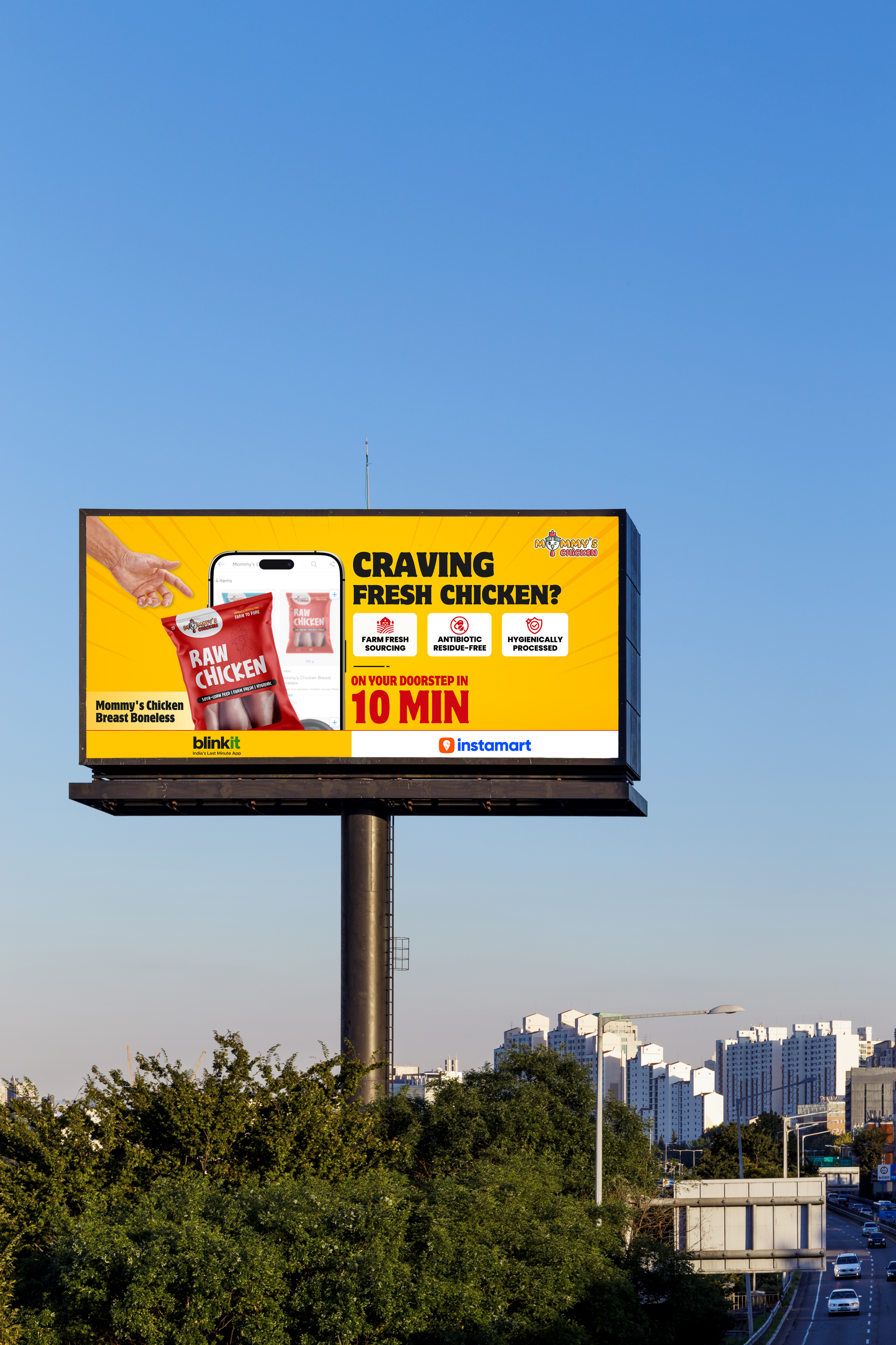 A roadside billboard against a clear blue sky advertising Mommy's Chicken boneless breast: 'Craving fresh chicken? On your doorstep in 10 min', with Blinkit and Instamart along the bottom