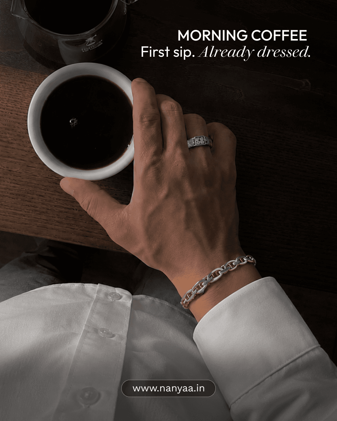 “Morning coffee — first sip, already dressed” post: a man’s hand in a white shirt cuff holding an espresso, wearing a silver ring and chain bracelet