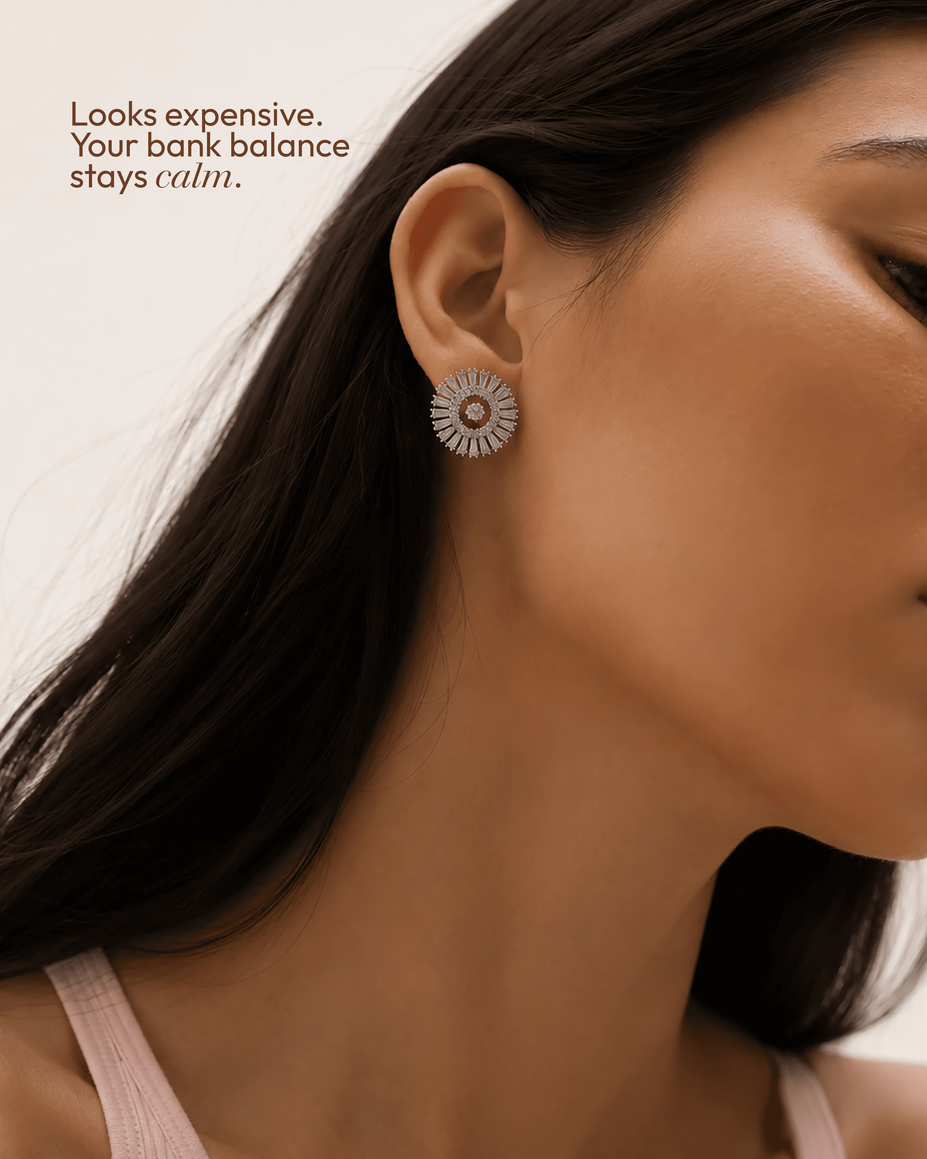“Looks expensive, your bank balance stays calm” post: a close profile of a woman wearing a silver sunburst stud earring